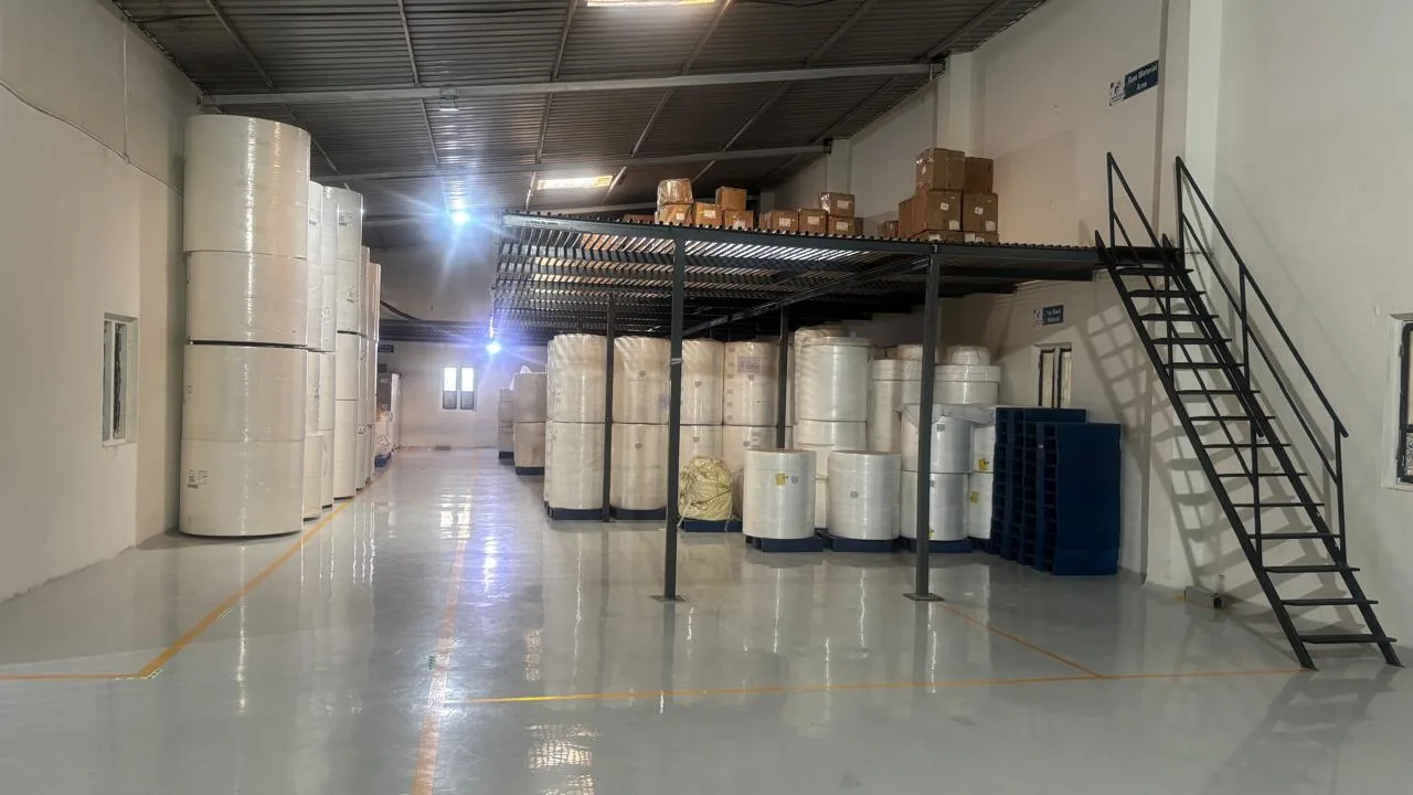 Raw material area with nonwoven and fluff pulp rolls for adult diaper production in India